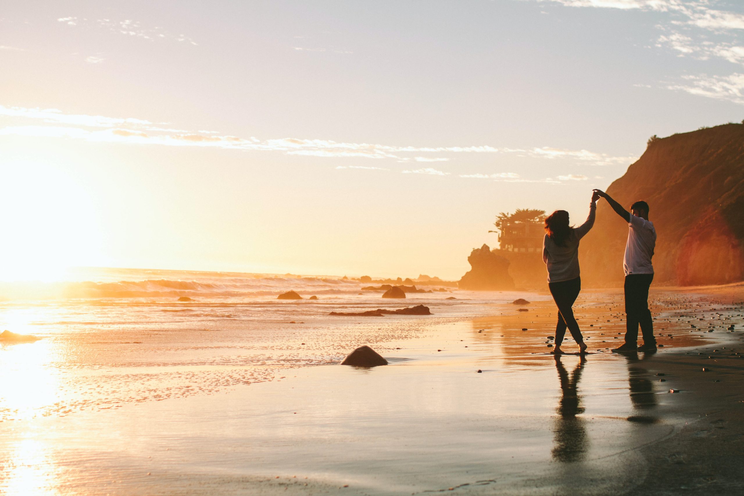 Couple dancing on a St. John USVI beach at sunset after their vow renewal