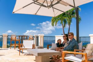 A family enjoying a view of Cruz Bay from an open-air patio at The Hills St. John