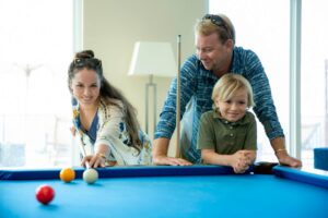 A family playing pool in the Clubhouse of The Hills St. John.