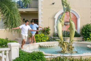 two boys playing around a fountain at The Hills St John in the USVI.