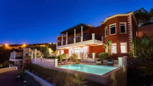 Exterior of Papaya Villa at night featuring their private pool at The Hills St. John.