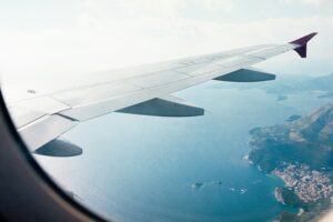 A view out the right side window of a jet passing over the coastline of St. John, USVI.