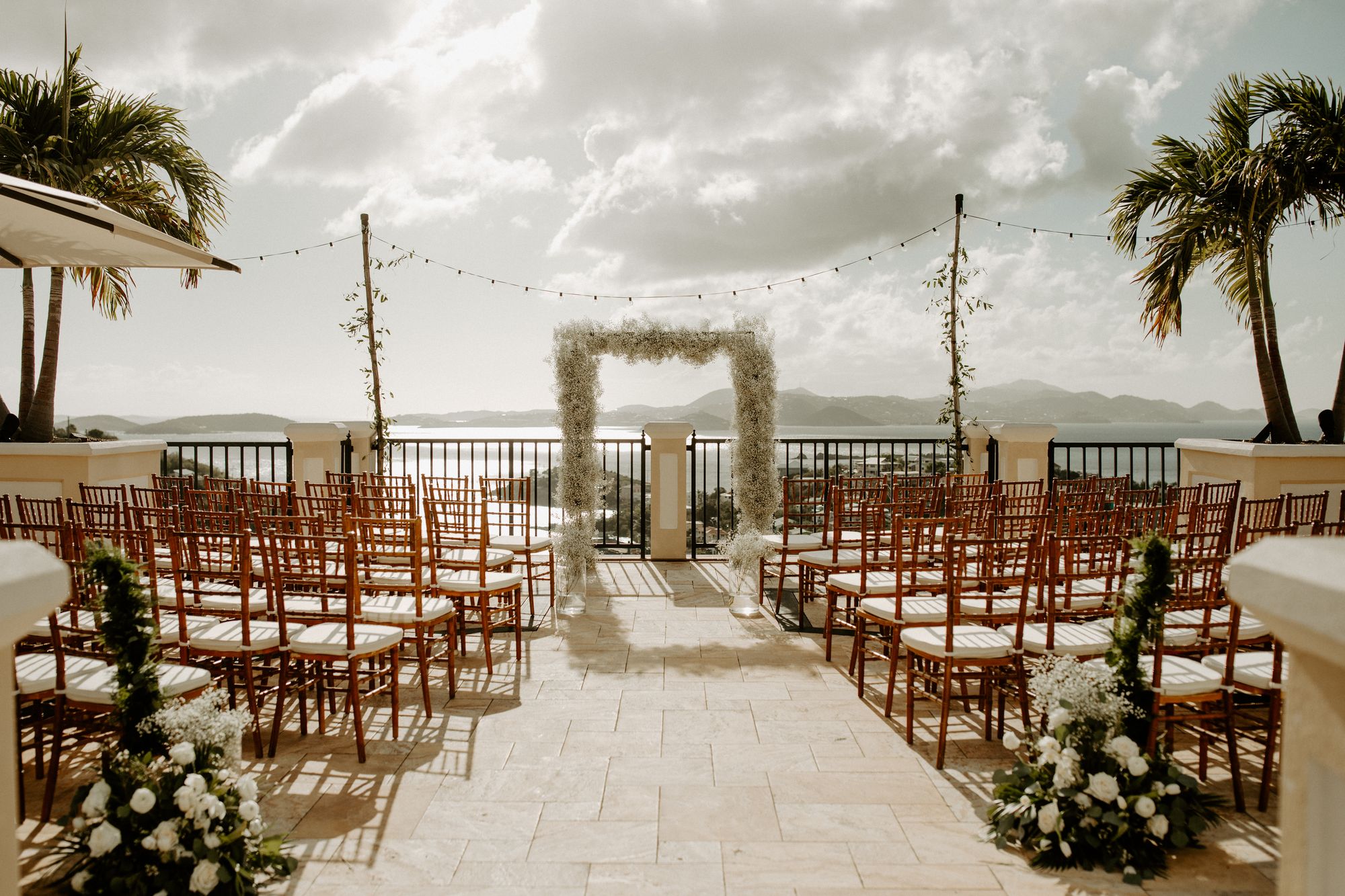 Ceremony setup with floral arch and aisle on the terrace at The Hills St. John