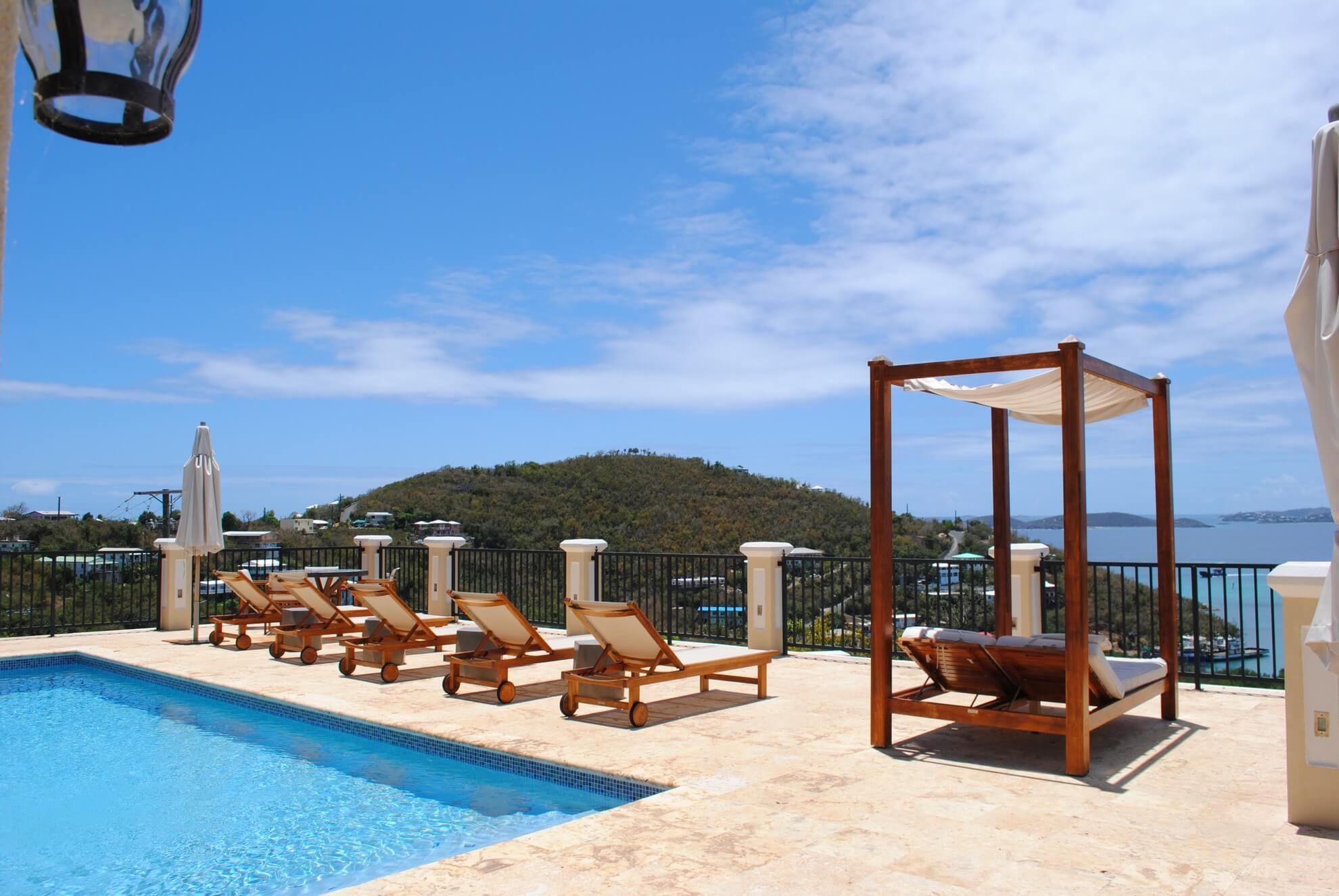 Pool deck with daybed and Caribbean views at The Hills St. John